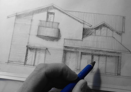 Drawing a house with a blue pen on a white background.
