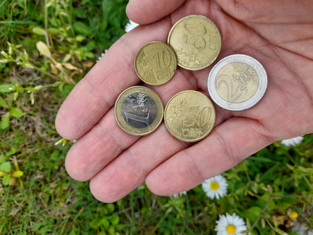 Euro coins in the hands of a man