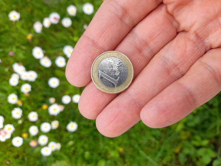 1 Euro Coin in Man's Hands