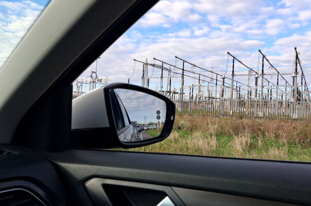 View from car window showing power plant and vegetationの写真素材