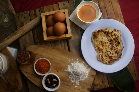 prata canai style  Pancake and ingredients for cooking on a wooden table, top viewの写真素材