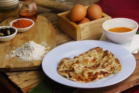 prata canai style Thin pancakes cook with malaysian choice spices on a wooden table.の写真素材
