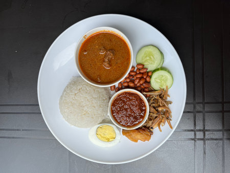 Nasi lemak is a malaysian dish consisting of rice, lentils and meatの写真素材