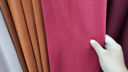 Photo of hands selecting fabric to buy, fabric sold in a clothing store. this photo is suitable for use in the textile industryの写真素材