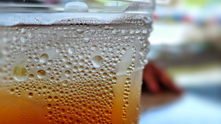 Close-up of refreshing cold tea in a plastic cup with condensation