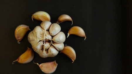Close-up of garlic cloves on a dark surface