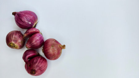 Close-up of Fresh Red Onions Isolated on a White Surfaceの写真素材