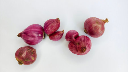 Close-up of Fresh Red Onions Isolated on a White Surfaceの写真素材