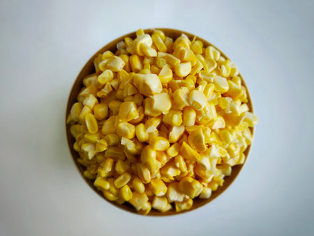 A bowl filled with fresh, golden corn kernels.の写真素材