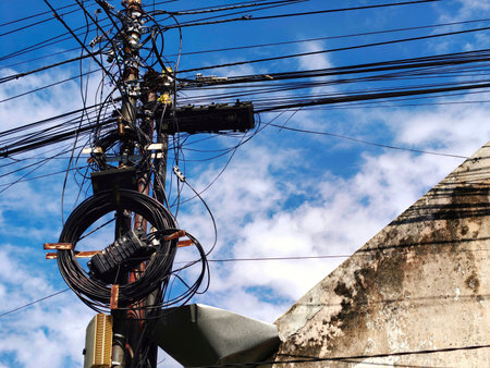 A messy coil of telephone cables on a pole, perfect for a technology concept