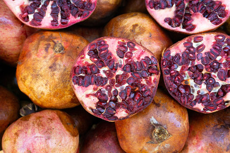 Footage of sliced ripe pomegranate in street food store. Cut fresh pomegranate close-up delicious...