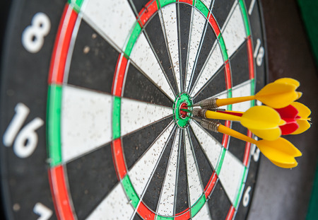 Darts hit the target all the media about the success of the teamの写真素材