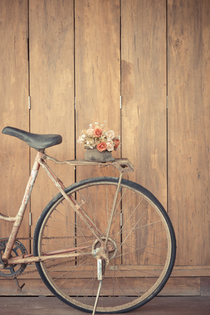 vintage bicycle on wooden house wallの写真素材