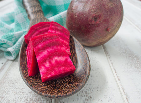Beetroot, cut into pieces, placed in a wooden spoonの写真素材