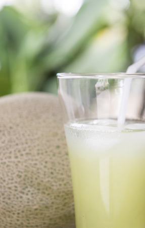 Watermelon juice into a glass place it on a wooden floor.の写真素材