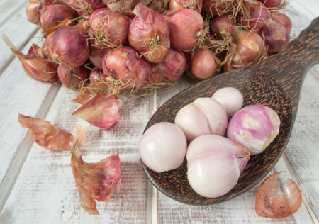 Onion peeled and placed in a wooden spoon