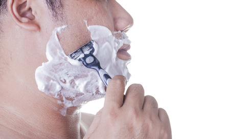 Man Using a razor to shaveの写真素材