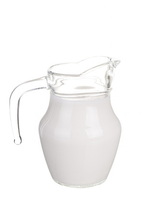 Glass jug of fresh milk isolated on white background.の写真素材