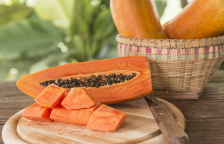 Papaya fruit sliced ââand placed on a piece of wood.の写真素材