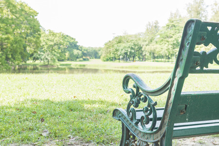 Green Chair in the park with pond.の写真素材