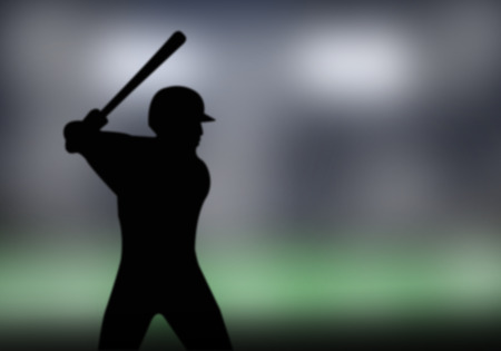 Silhouette of a baseball player hitting the field.の写真素材