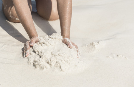 Woman hand shoveled sand together, white sand on Koh Tachai. Phangnga, Thailand.の写真素材