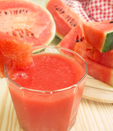 Watermelon smoothie with watermelon fruit on top of glassの写真素材