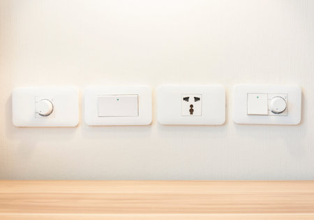 Electronic light switches and plug sockets mounted on the wall.