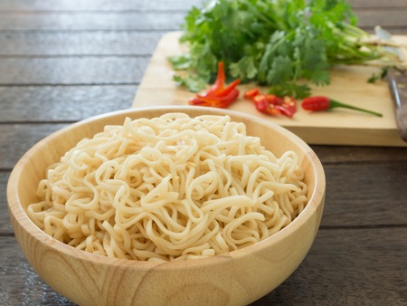 Instant noodles in bowls on wood table. top viewの写真素材