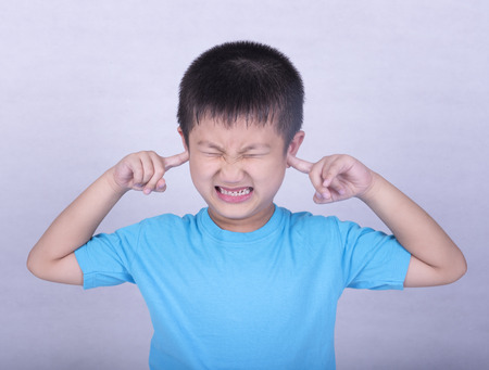 Children suffering from earache from listening to loud noise and the stress and depression.の写真素材