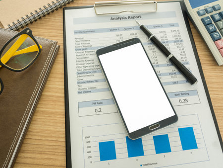 smart phone on work desk with notebook ,report, pen.