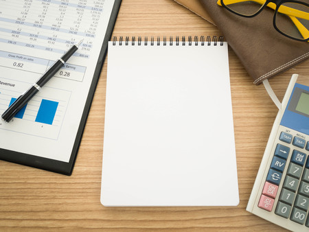 Notebook on the desk with the analysis report , Pens, calculators.の写真素材