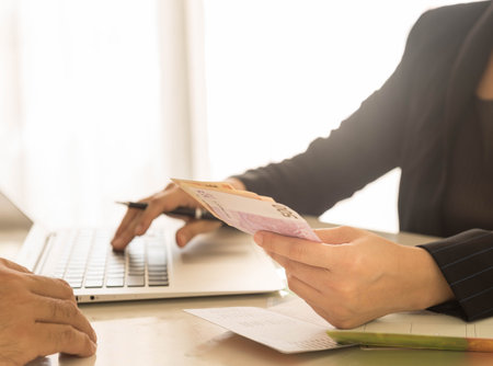 Bank employees are receiving deposits or payments from customersの写真素材