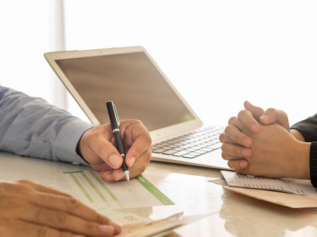 Businessman is writing a deposit slip. Businessman is writing a deposit slip.