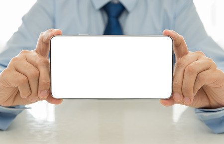 Businessman show mobile screen. free space for text.の写真素材