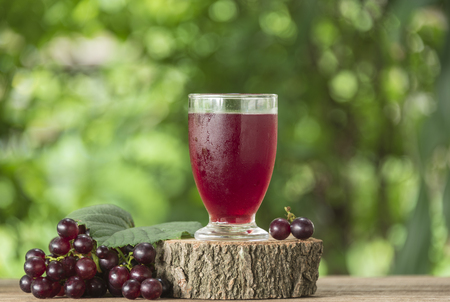 Grape juice in a glass on the table.の写真素材