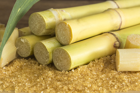 closeup granulated brown sugar on a wooden table.の写真素材