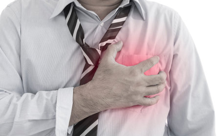 Front view of a young businessman heart  muscle pain (heart disease). Red around the pain area.