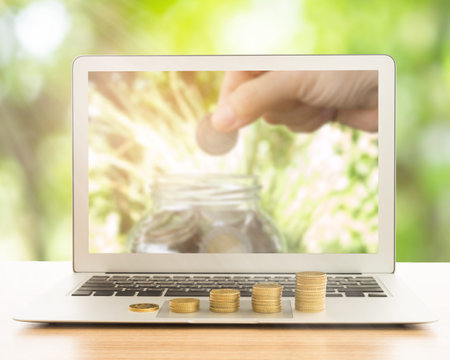 stack of gold coins on laptop computer. concept of business growth, development, investment growth, investment concept, growth concept.の写真素材