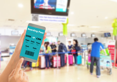 Using mobile smart phone Check In Airport Flight. Traveling Conceptの写真素材