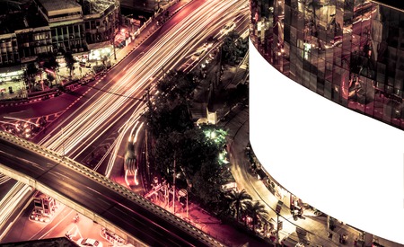 blank billboard on building, blank billboard during the Night, blank billboard in city background. Vintage Style.- can be used for display your products or promotionalの写真素材