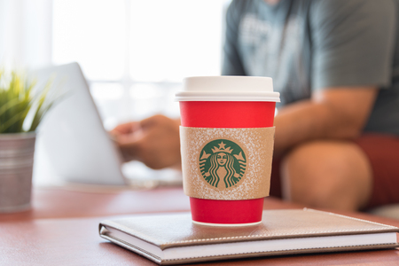 Bangkok, Thailand - October 5, 2016: The new paper cup of Starbucks stores in the country for the Christmas on a red background cup. Starbucks brand is one of the world famous from USA.のeditorial素材