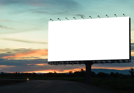 Blank billboard on the highway during the twilight. With clipping path on screen - can be used for trade shows, and advertising or promotional poster for you.の写真素材