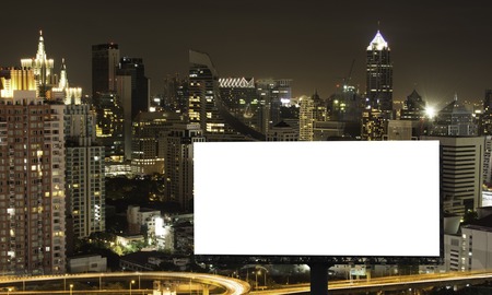 Blank billboard with a background of city. With clipping path on screen - can be used for trade shows, and advertising or promotional poster for you.の写真素材