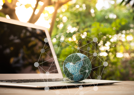 mock up the globe  with digital social media network on keyboard laptop computer in nature backgroundの写真素材