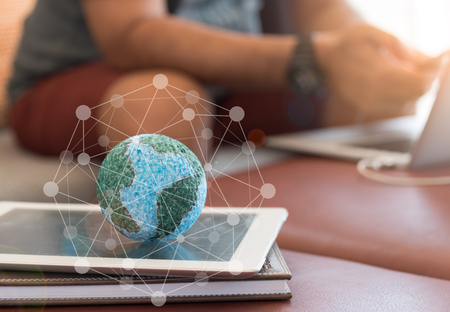 Mock up the globe with digital social media network on notebook at home. Concept of Connection, Communication, Technology, Network.の写真素材