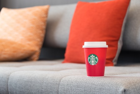 Bangkok, Thailand - October 4, 2016: The new paper cup of Starbucks stores in the country for the Christmas on a red background cup. Starbucks brand is one of the world famous from USA.のeditorial素材