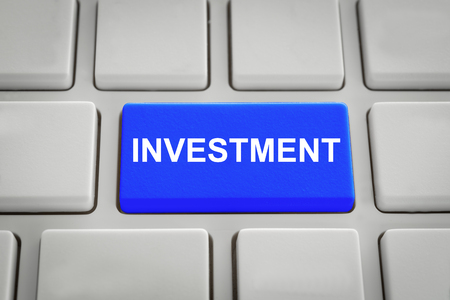 Invest concept. Keyboard with blue button on the investment.の写真素材