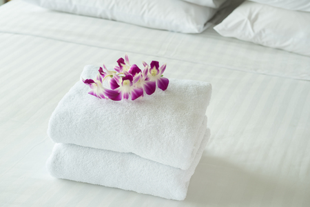 Close up, Fresh white Towel with flowers placed on the inside of the hotel room.の写真素材