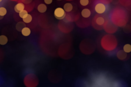 abstract blurred bokeh light in dark tone background.
